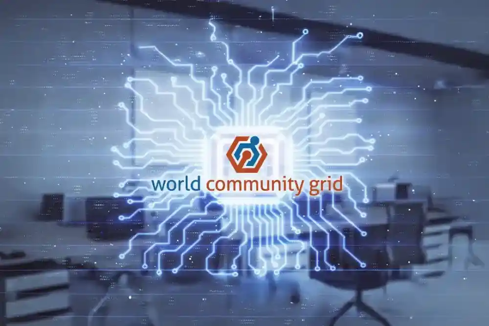 A stylized graphic featuring the World Community Grid logo at the centre, surrounded by a circuit-like design illuminated in blue. The background shows a blurred office setting with desks and chairs.