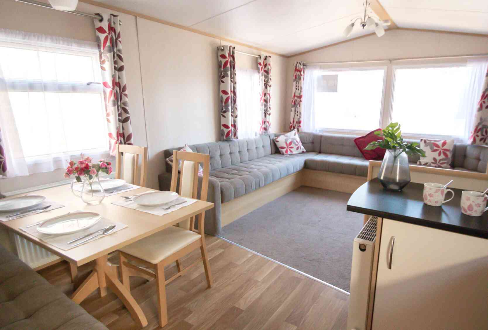 A cosy living area featuring a table surrounded by chairs, creating an inviting space for gatherings.