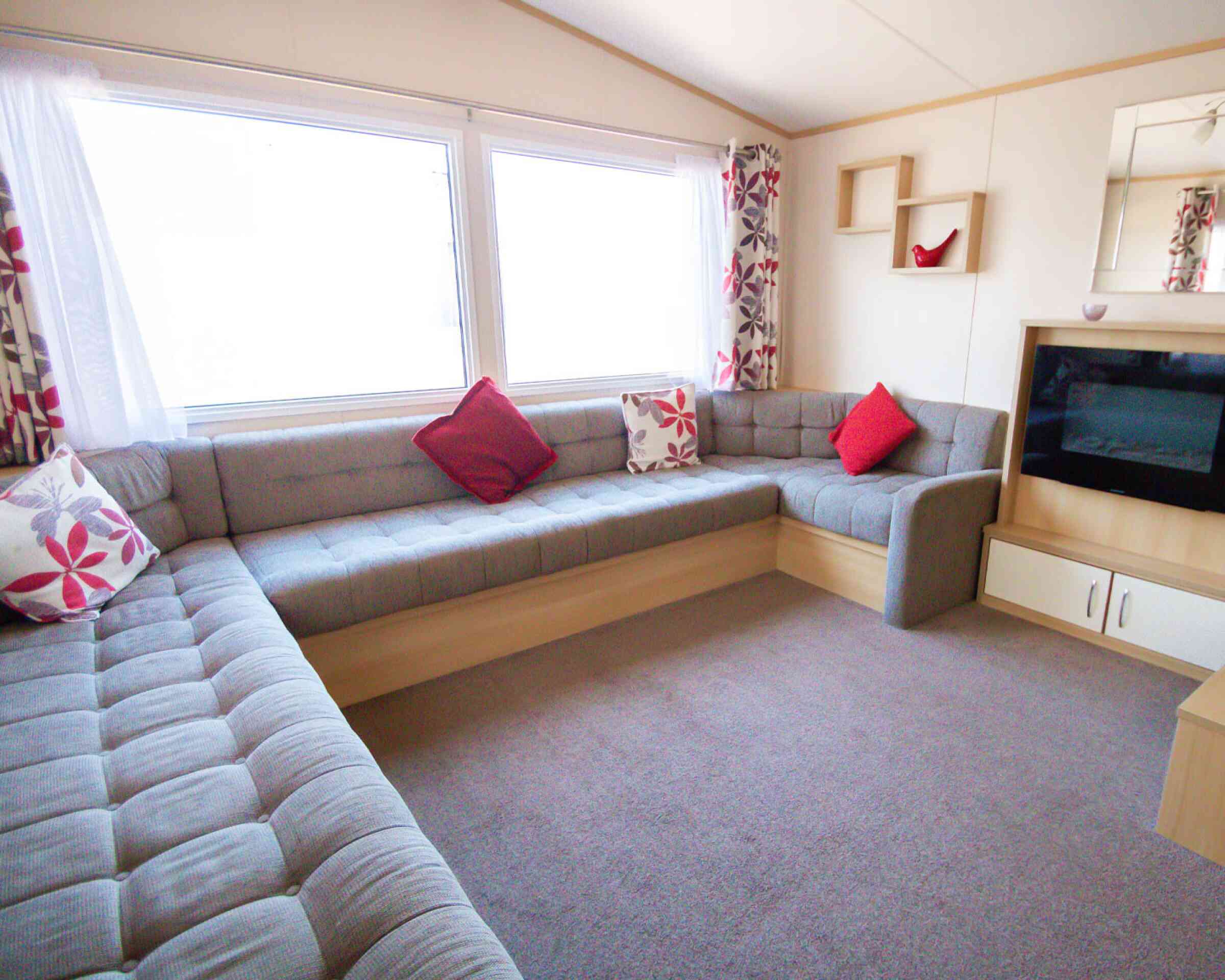 A stylish living room with a couch, a television, and a coffee table, designed for leisure and socializing.