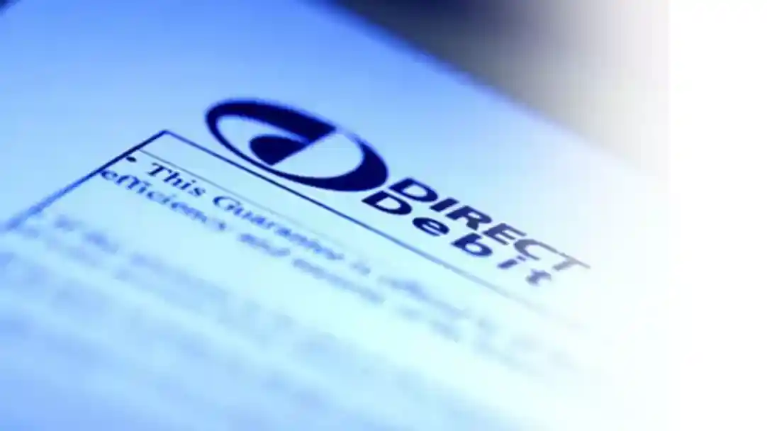 Close-up of a document featuring the logo of Direct Debit, highlighting a guarantee statement related to direct debit transactions.